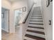 Staircase with wooden treads and white risers connecting the levels of the home at 1342 Salmonberry St, Wesley Chapel, FL 33543