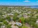 Lovely aerial view of a tree-lined neighborhood featuring a home with solar panels and picturesque lake views at 1400 Cherry Ne St, St Petersburg, FL 33704