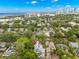 Desirable neighborhood with this home, showcasing solar panels, mature trees, and proximity to the city skyline at 1400 Cherry Ne St, St Petersburg, FL 33704