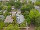 Gorgeous aerial view showcases this home, with solar panels, nestled among mature trees and beautiful landscaping at 1400 Cherry Ne St, St Petersburg, FL 33704