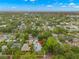Charming neighborhood with a home with solar panels surrounded by mature trees and lush green landscape at 1400 Cherry Ne St, St Petersburg, FL 33704