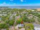 Beautiful aerial view of a home with solar panels in a serene, tree-lined neighborhood near the water at 1400 Cherry Ne St, St Petersburg, FL 33704
