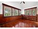 Sun-filled bedroom with beautiful wood trim, hardwood floors, a ceiling fan, and three large windows at 1400 Cherry Ne St, St Petersburg, FL 33704