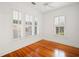 Bright bedroom features hardwood floors, white trim, plantation shutters, and a ceiling fan at 1400 Cherry Ne St, St Petersburg, FL 33704