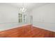 A bright dining room with hardwood floors, a decorative chandelier, and large window at 1400 Cherry Ne St, St Petersburg, FL 33704