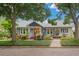 Charming blue two-story home with brick pathway, lush landscaping, and welcoming front porch at 1400 Cherry Ne St, St Petersburg, FL 33704