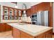 A well-equipped kitchen featuring custom wood cabinets, stainless steel appliances, and a large island with a sink at 1400 Cherry Ne St, St Petersburg, FL 33704