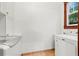 Laundry room with tiled floor, laundry sink, Maytag washer and dryer, and a window at 1400 Cherry Ne St, St Petersburg, FL 33704