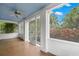Charming screened-in porch with tiled floor, ceiling fan, white trim and large windows at 1400 Cherry Ne St, St Petersburg, FL 33704