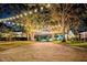 Charming neighborhood street with brick roads and mature trees covered in decorative lights at 1400 Cherry Ne St, St Petersburg, FL 33704