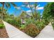 Landscaped corner lot with mature trees and lush greenery, offering privacy and curb appeal at 1400 Cherry Ne St, St Petersburg, FL 33704