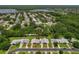 Aerial view shows the layout of the community, water features, and single story homes at 1401 Camelot Ct, Palm Harbor, FL 34684