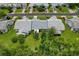 Aerial view of home in a well-maintained neighborhood and landscaping at 1401 Camelot Ct, Palm Harbor, FL 34684