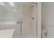 Tiled shower stall with sliding glass doors in a bathroom featuring a toilet and white walls at 1401 Camelot Ct, Palm Harbor, FL 34684