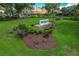 Landscaped entrance sign for Highland Lakes Club with lush greenery and vibrant flowers at 1401 Camelot Ct, Palm Harbor, FL 34684