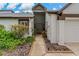 Charming front entrance with a decorative walkway, beautiful plants, and a well-maintained lawn at 1401 Camelot Ct, Palm Harbor, FL 34684