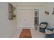 Cozy front porch area featuring tiled floors, rattan chairs and double door entryway at 1401 Camelot Ct, Palm Harbor, FL 34684