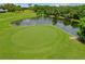 Beautiful golf course view with a pond, lush greenery, mature trees, and a serene setting at 1401 Camelot Ct, Palm Harbor, FL 34684