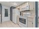 Kitchen featuring white appliances including a range oven, and refrigerator set against blue checkered wallpaper at 1401 Camelot Ct, Palm Harbor, FL 34684