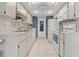 Bright kitchen with white appliances, cabinets, and tiled floors, featuring a built-in microwave and a ceiling fan at 1401 Camelot Ct, Palm Harbor, FL 34684