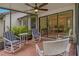 The screened lanai has tile floor, seating and access to the dining area at 1401 Camelot Ct, Palm Harbor, FL 34684
