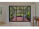 Enclosed lanai featuring tile flooring, ceiling fan, and views of the backyard at 1401 Camelot Ct, Palm Harbor, FL 34684