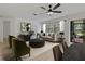 Bright living room offering neutral color palette, ceiling fan, and sliding doors to patio at 1401 Camelot Ct, Palm Harbor, FL 34684