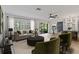 Living room featuring light wood floors, neutral palette, ceiling fan, and sliding doors to patio at 1401 Camelot Ct, Palm Harbor, FL 34684