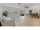 Bright living room featuring hardwood floors, plantation shutters and sliding door access to the outside at 1401 Camelot Ct, Palm Harbor, FL 34684
