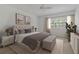 Comfortable main bedroom featuring neutral decor, plantation shutters and hardwood floors at 1401 Camelot Ct, Palm Harbor, FL 34684