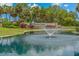 Pond and water fountain at Highland Lakes Active Adult Golf Community entrance at 1401 Camelot Ct, Palm Harbor, FL 34684