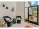Cozy porch area featuring tiled floors, rattan chairs and garden decor at 1401 Camelot Ct, Palm Harbor, FL 34684