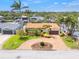 Aerial view of a lovely home featuring lush landscaping, a brick driveway, and a well-maintained exterior at 1424 47Th Ne Ave, St Petersburg, FL 33703