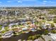 Breathtaking aerial view of a canal-front home in a residential neighborhood with waterfront access and lush greenery at 1424 47Th Ne Ave, St Petersburg, FL 33703
