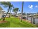 Waterfront property featuring a well-manicured lawn and a private boat dock at 1424 47Th Ne Ave, St Petersburg, FL 33703
