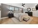 Bedroom with hardwood floors, ceiling fan, neutral paint colors, and plantation shutters at 1424 47Th Ne Ave, St Petersburg, FL 33703