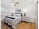 Well-lit bedroom featuring hardwood floors, a ceiling fan, and a comfortable queen-sized bed at 1424 47Th Ne Ave, St Petersburg, FL 33703