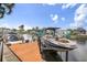 Boat lift showcasing a modern boat, set against a scenic waterfront backdrop at 1424 47Th Ne Ave, St Petersburg, FL 33703