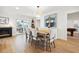 Sunlit dining room with fireplace and sliding glass doors to the outdoor living area at 1424 47Th Ne Ave, St Petersburg, FL 33703
