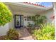 Inviting front entryway with lush tropical landscaping leading to a modern glass front door at 1424 47Th Ne Ave, St Petersburg, FL 33703