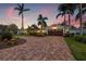 Charming home with a beautiful brick driveway and a well-maintained lawn with lovely palm trees at 1424 47Th Ne Ave, St Petersburg, FL 33703