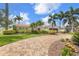 Beautiful home with a tile roof, circular brick driveway, and meticulously maintained landscaping at 1424 47Th Ne Ave, St Petersburg, FL 33703