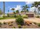 Charming home featuring a paver driveway, lush landscaping, mature palm trees, and a well-manicured lawn under a bright blue sky at 1424 47Th Ne Ave, St Petersburg, FL 33703