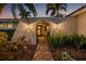 Charming front entrance showcasing lush landscaping and a welcoming arched entryway at 1424 47Th Ne Ave, St Petersburg, FL 33703
