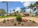 Well-maintained home featuring a circular brick driveway and tropical landscaping with mature palm trees at 1424 47Th Ne Ave, St Petersburg, FL 33703