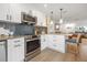 Beautiful kitchen features stainless steel appliances and island with seating at 1424 47Th Ne Ave, St Petersburg, FL 33703
