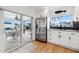 Open kitchen featuring stainless steel appliances, white cabinets, and views of the lanai and pool at 1424 47Th Ne Ave, St Petersburg, FL 33703