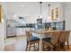 Bright kitchen with modern stainless steel appliances, white cabinetry, and breakfast bar with seating at 1424 47Th Ne Ave, St Petersburg, FL 33703