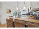 Bright kitchen with stainless steel appliances, white cabinetry, breakfast bar and pendant lights at 1424 47Th Ne Ave, St Petersburg, FL 33703