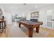 Bright open living room featuring a wooden pool table and views into the modern kitchen at 1424 47Th Ne Ave, St Petersburg, FL 33703
